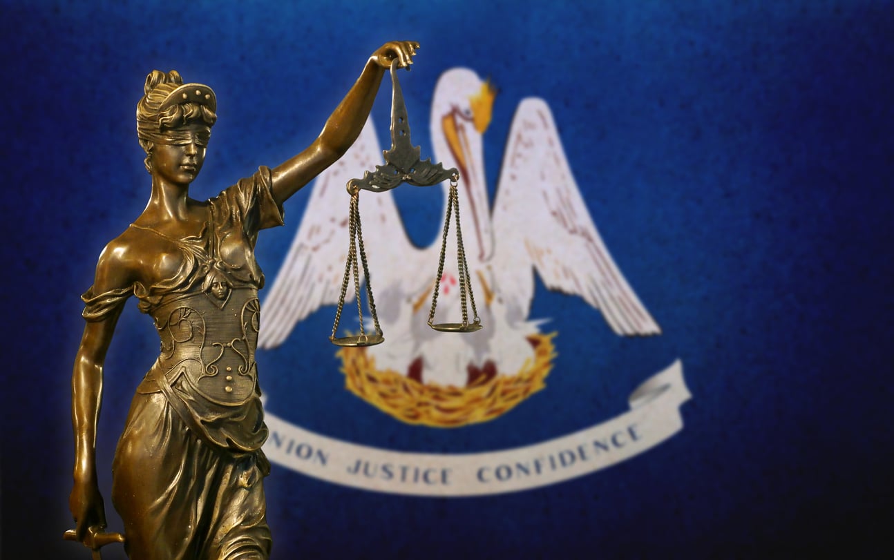Indecent Behavior with a Juvenile Defense Lawyer in Louisiana 4 Lady Justice before a Louisiana flag symbolizing a defense of the accused in Louisiana