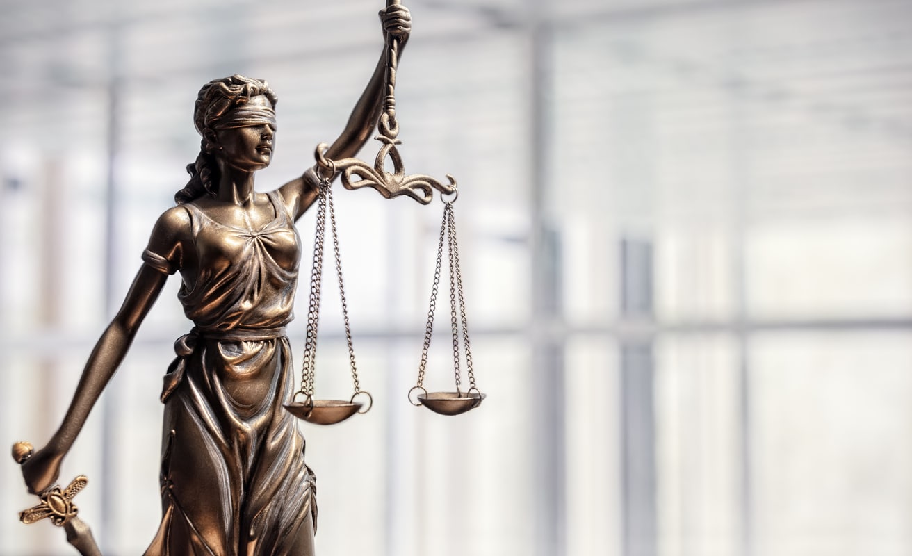 Lady Justice Statue of Lady Justice with scales of justice representing The Ambeau Law Firm commitment to integrity